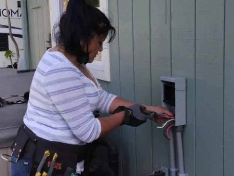 Licensed electrician wiring an exterior subpanel in Greene